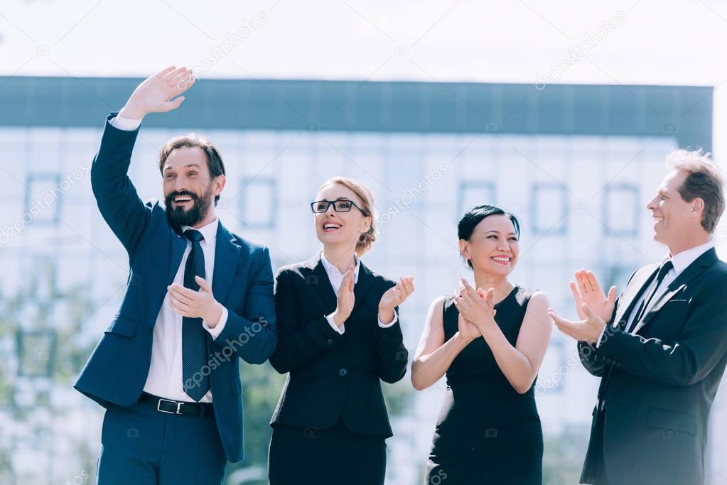 multiethnic businesspeople applauding