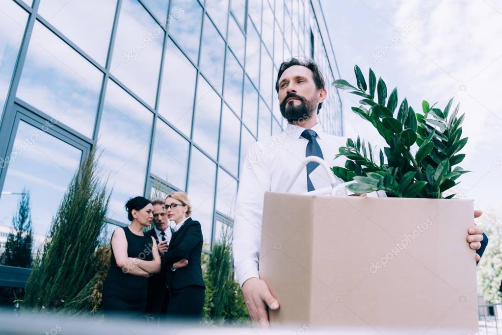 fired businessman with cardboard box 