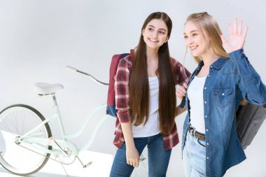 smiling teenagers waving to friend clipart