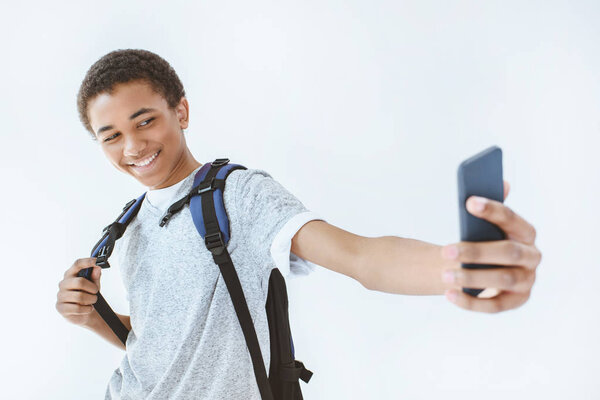 african american teenage boy taking selfie