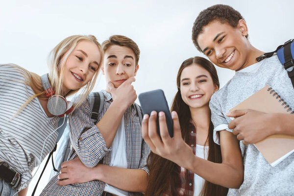 multicultural teenagers with smartphone