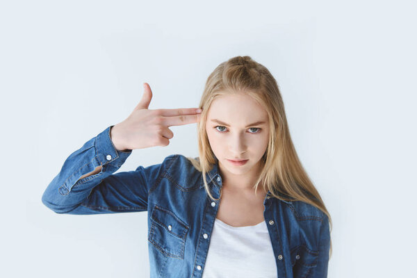 teenager with hand near head