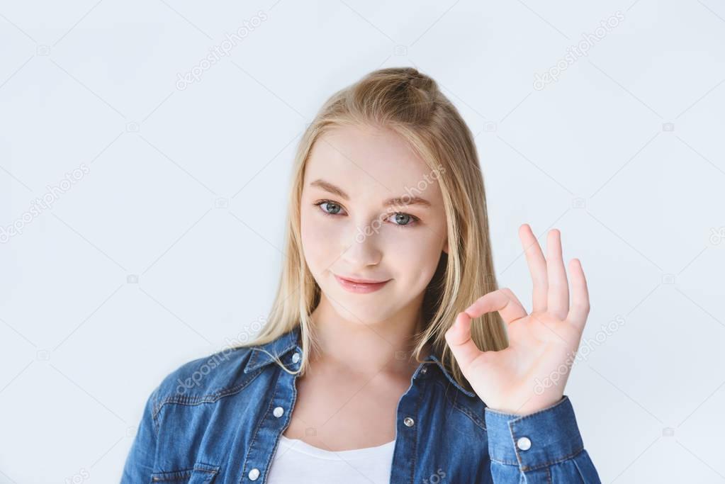 teenage girl showing ok sign