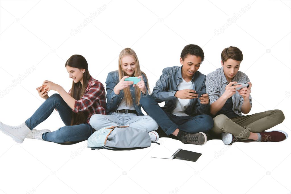 multicultural teenagers using smartphones