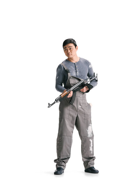 asian terrorist in dirty overall with rifle