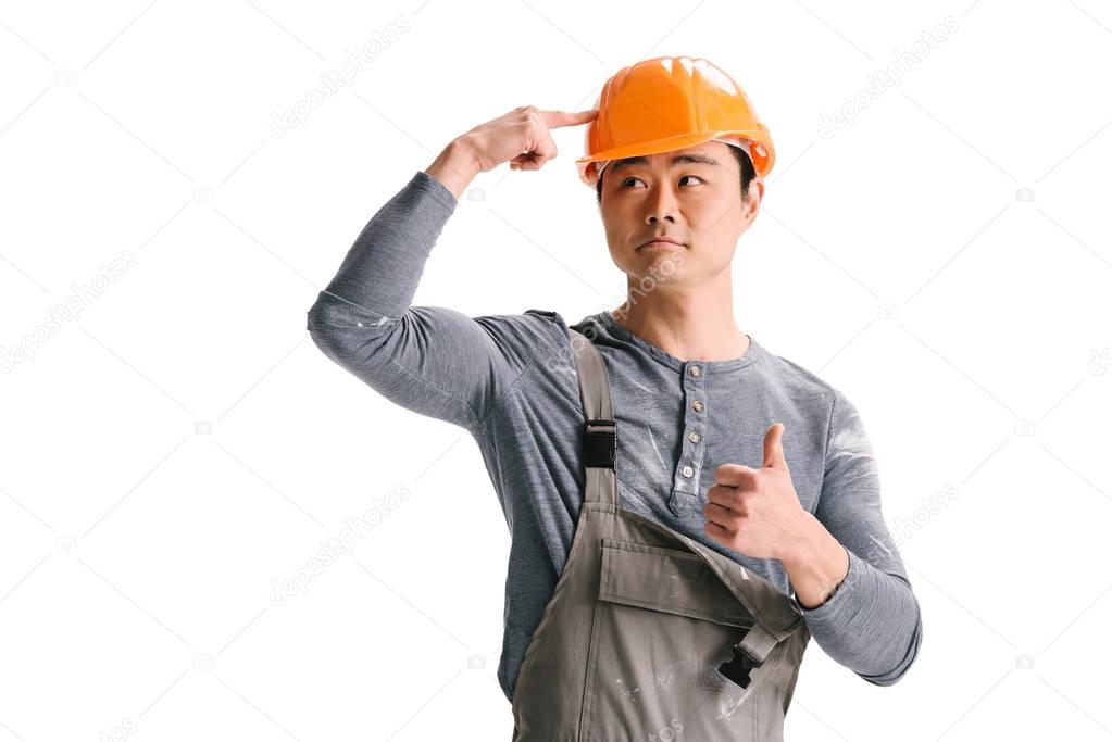 construction worker ponting at helmet