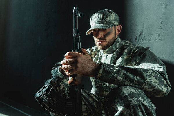 soldier in military uniform with rifle