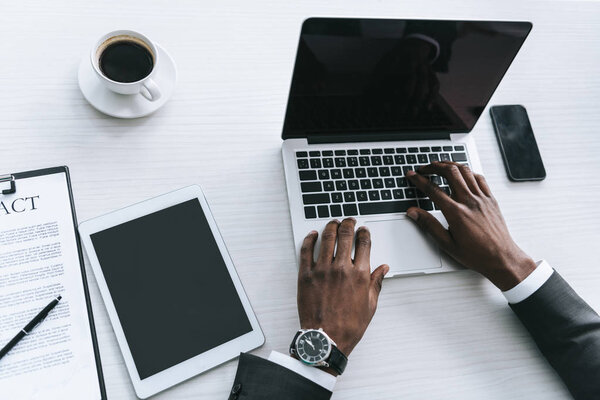african american businessman typing on laptop