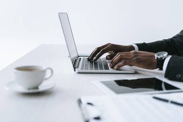 african american businessman typing on laptop