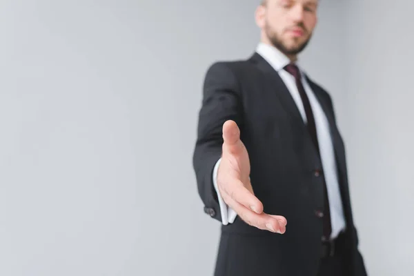 Businessman with outstretched hand — Stock Photo, Image