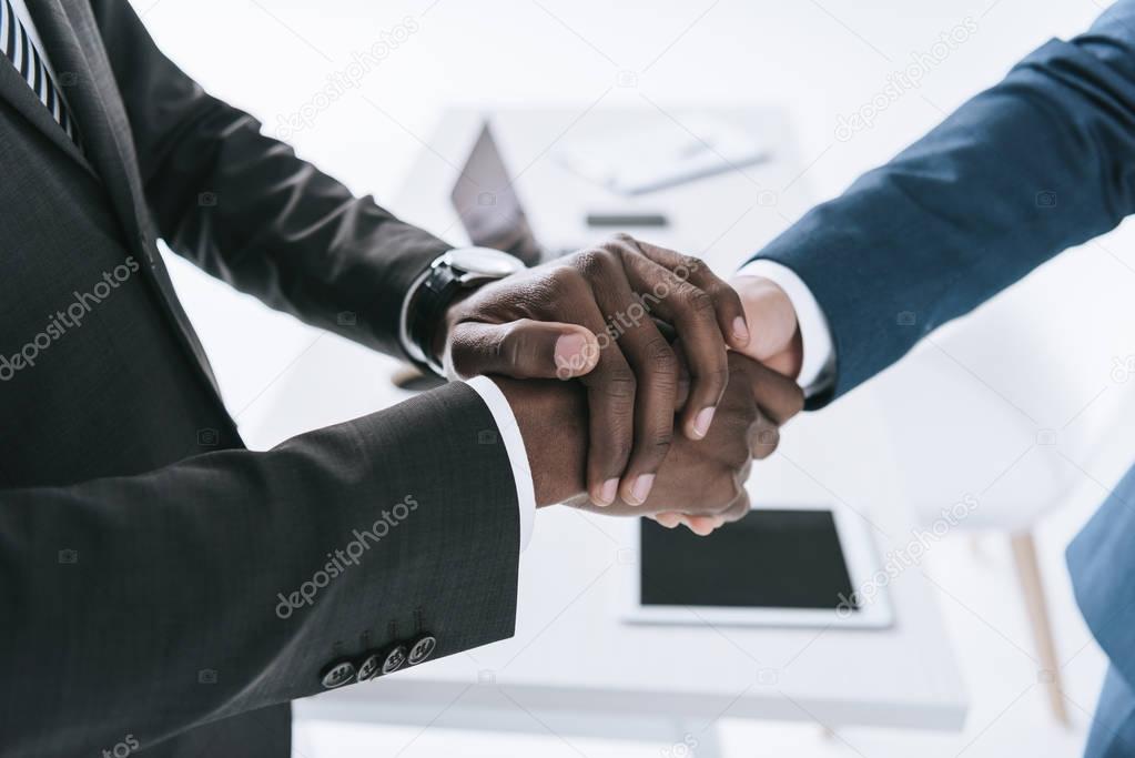 multicultural businessmen handshake