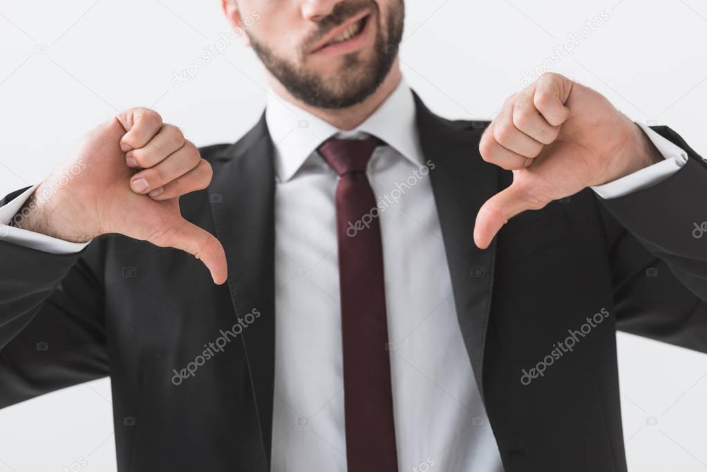 businessman showing thumbs down