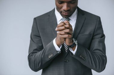 praying african american businessman