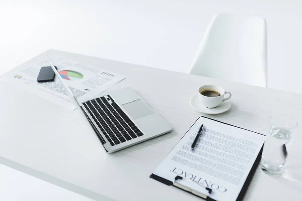 Laptop and contract at workplace — Stock Photo, Image