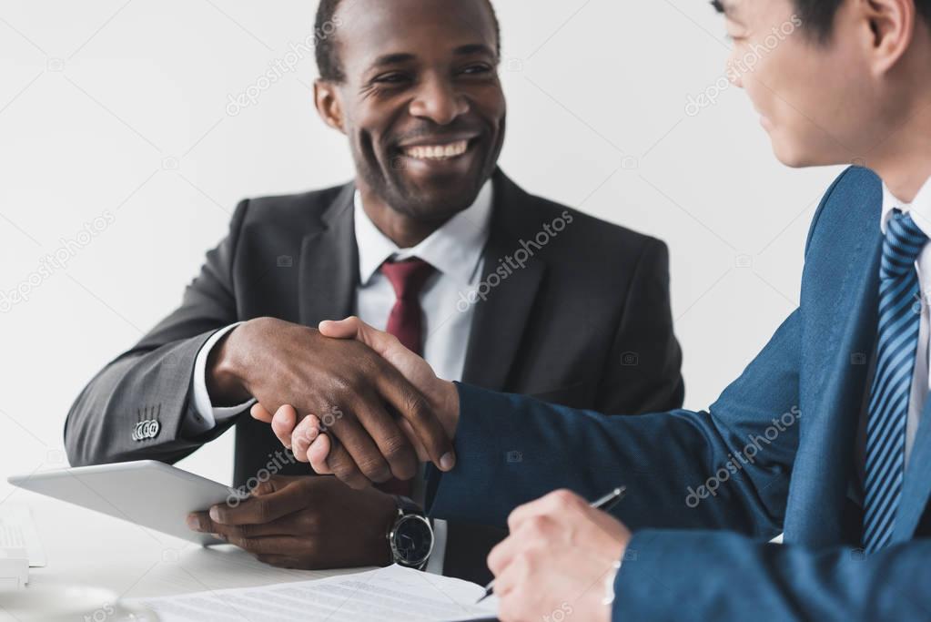 multiethnic businessmen shaking hands