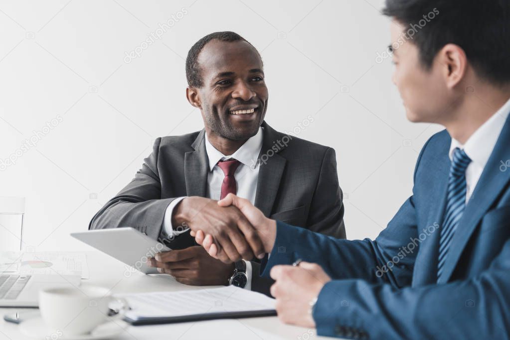 multiethnic businessmen shaking hands