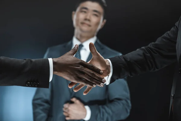 Multiethnic business partners shaking hands — Stock Photo, Image