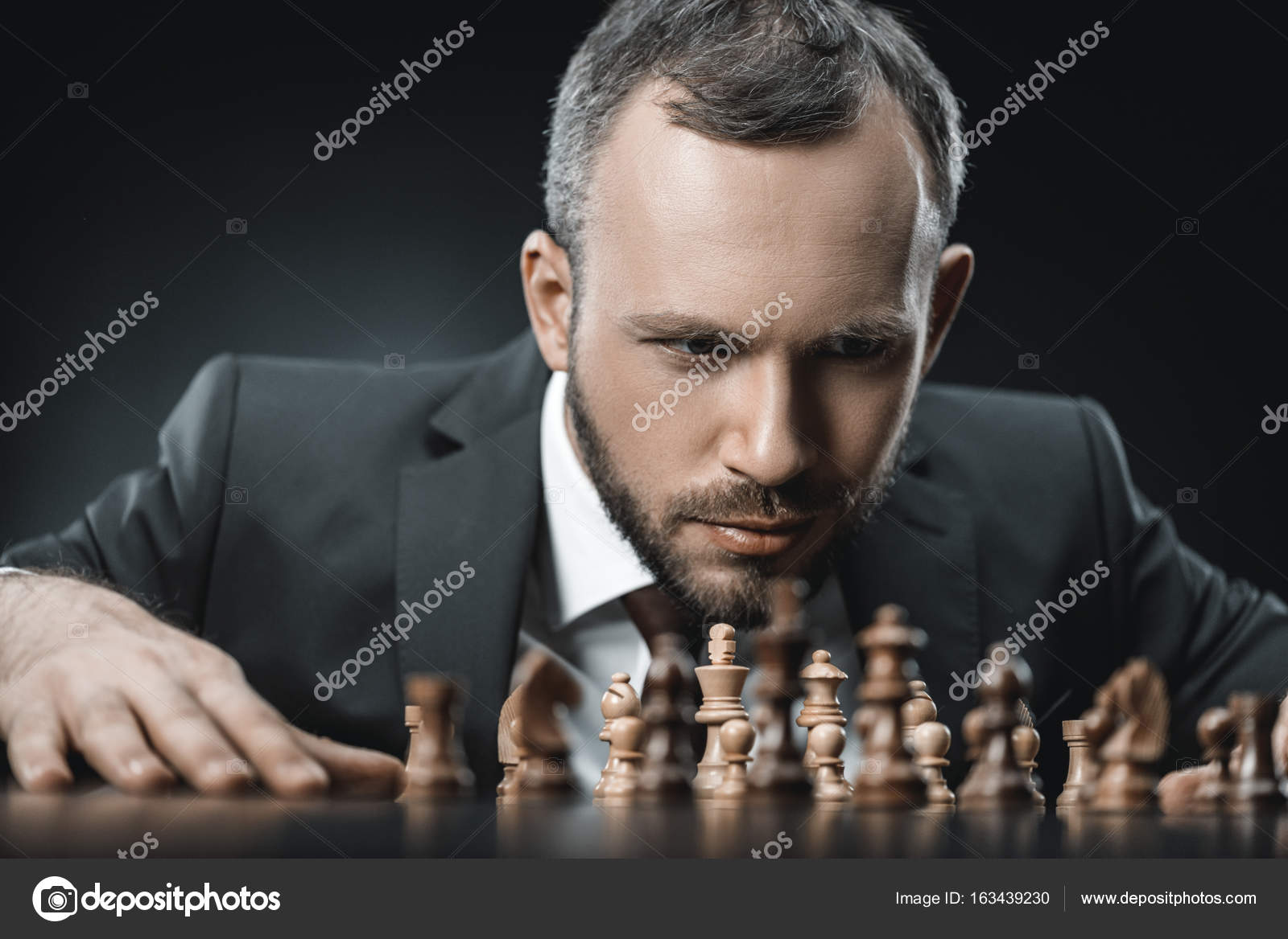 Pensive businessman and chess Stock Photo by ©TarasMalyarevich 163439230
