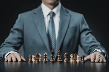 businessman and chess figures on table