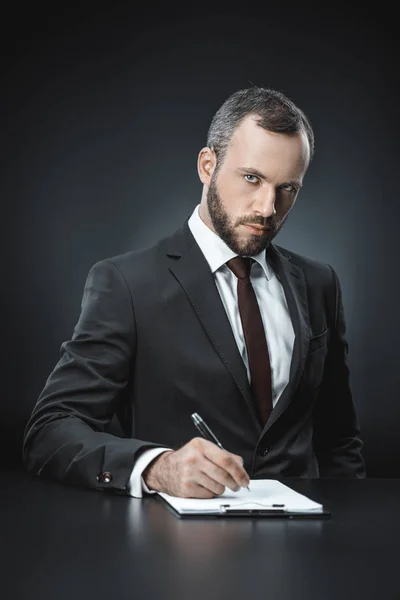 Confident businessman with document — Stock Photo, Image