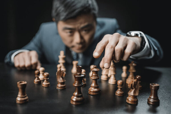 asian businessman playing chess