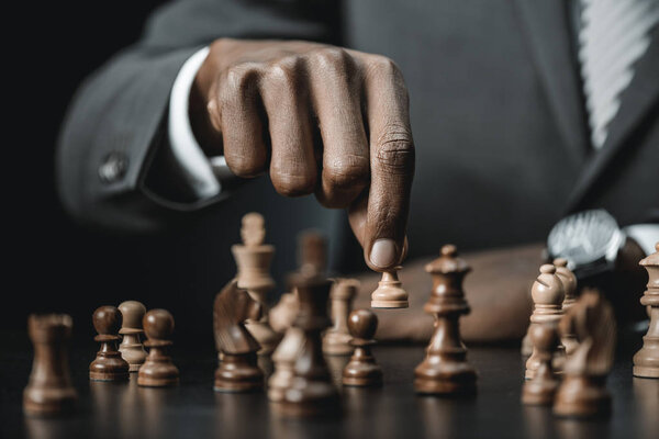 african american businessman playing chess