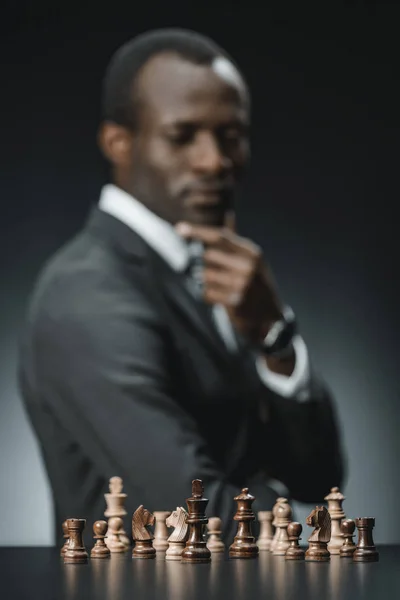 Pensive african american businessman and chess — Stock Photo, Image