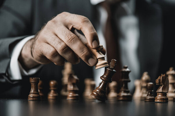 businessman and chess figures on table