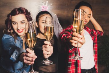 multicultural women with champagne at hen party clipart
