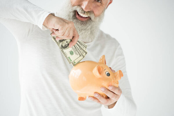 man with dollars and piggy bank
