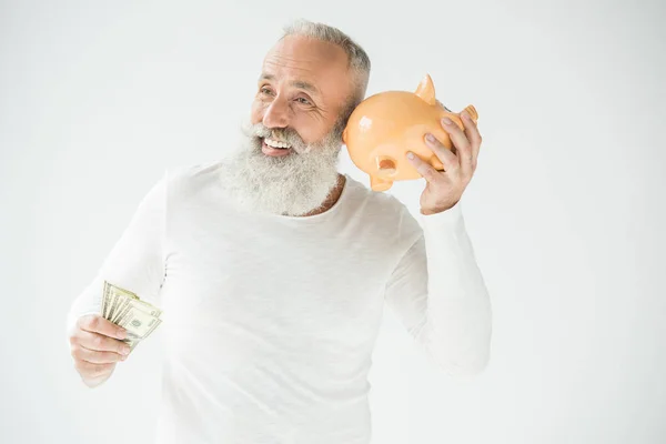 Homem com dólares e mealheiro — Fotografia de Stock