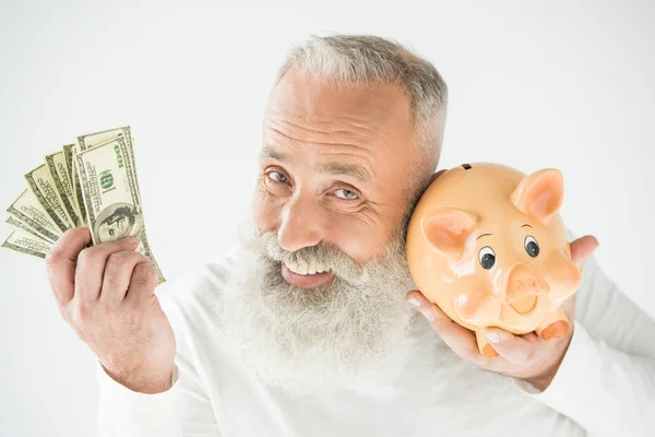 Hombre con dólares y alcancía — Foto de Stock