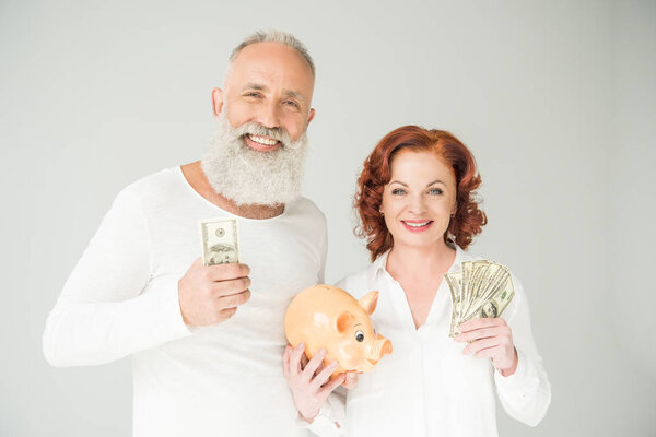 couple with dollars and piggy bank