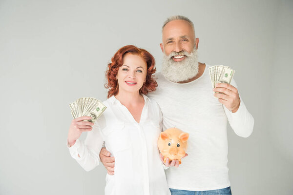 couple with dollars and piggy bank