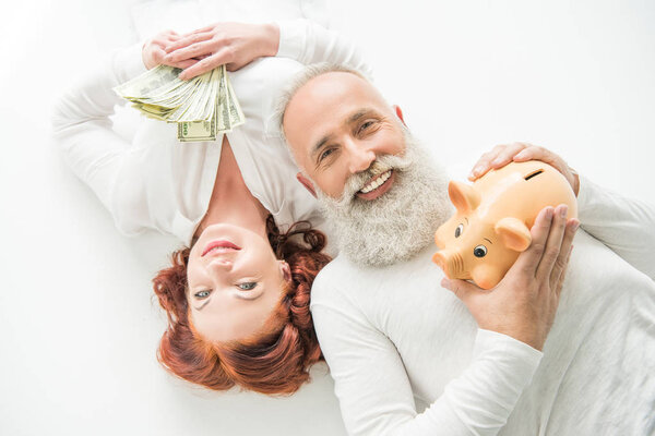 couple with dollars and piggy bank