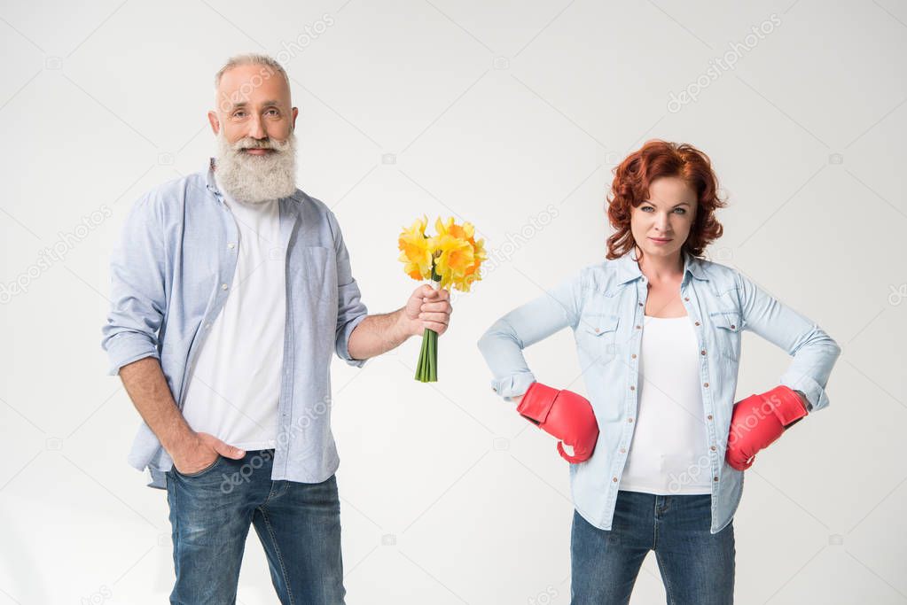 woman in boxing gloves and husband with bouquet