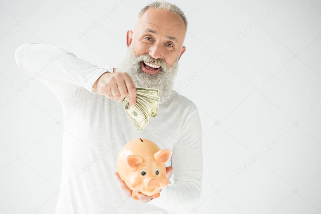 man with dollars and piggy bank