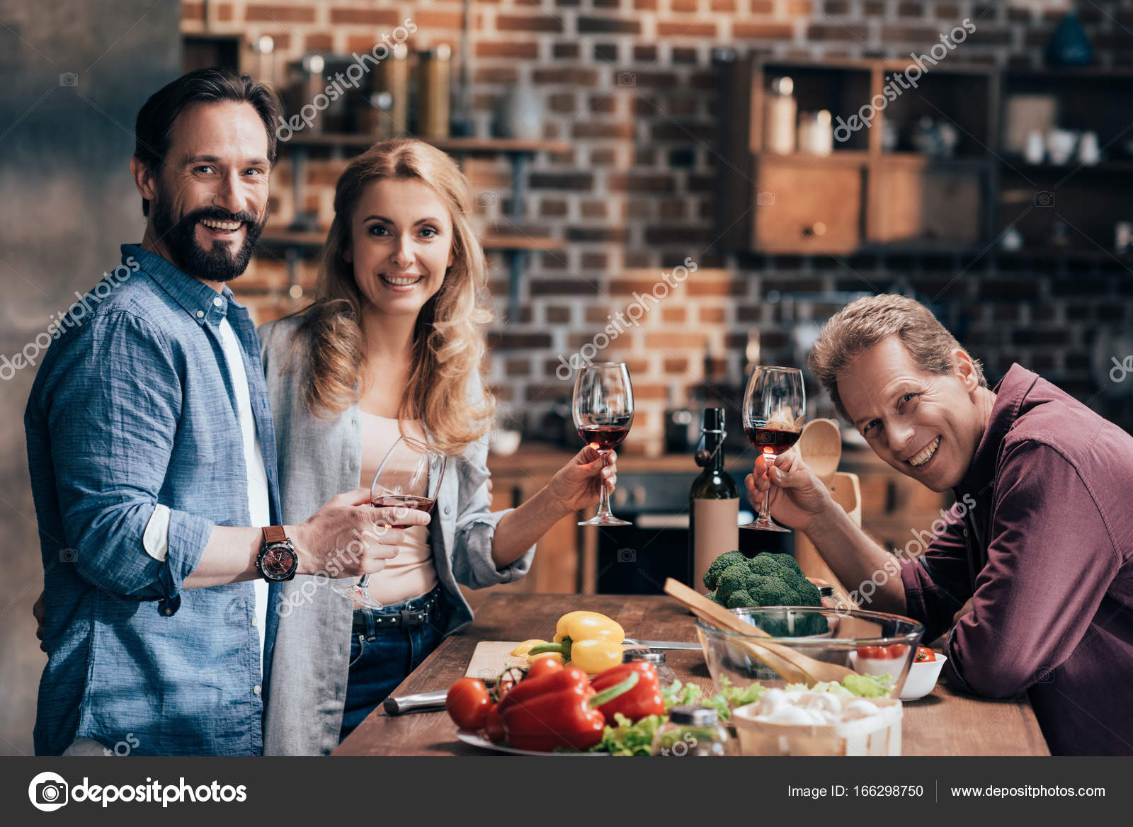 Friends drinking wine while cooking dinner — Stock Photo