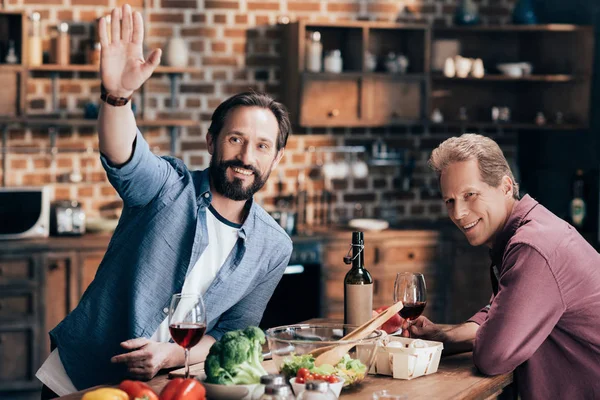 Men drinking wine in kitchen — Stock Photo, Image