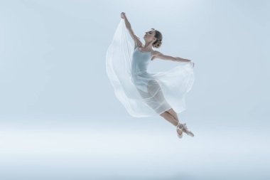 elegant ballet dancer in white dress jumping in studio, isolated on white clipart