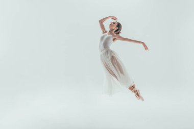elegant ballet dancer in white dress jumping in studio, isolated on white clipart