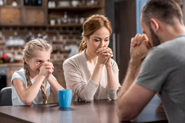 Young family praying — Stock Photo