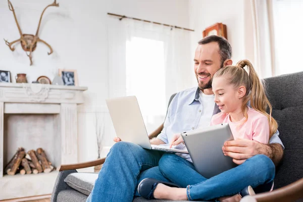 Pai e filha usando dispositivos — Fotografia de Stock