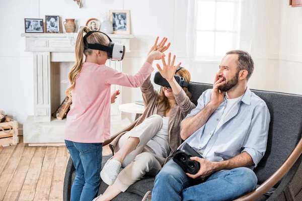 Family in virtual reality headsets — Stock Photo