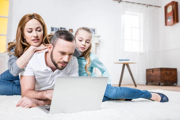 Familia usando laptop - foto de stock