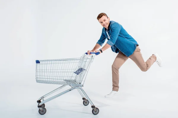 Young man with shopping trolley — Stock Photo