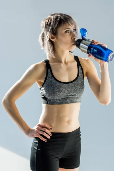 Sporty woman with bottle of water — Stock Photo