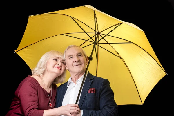 Senior couple with umbrella — Stock Photo