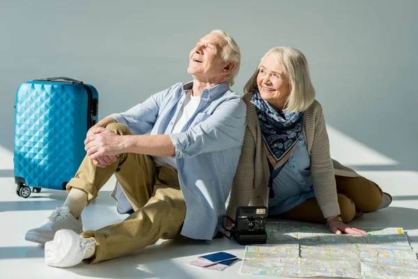 Senior couple with traveling map — Stock Photo