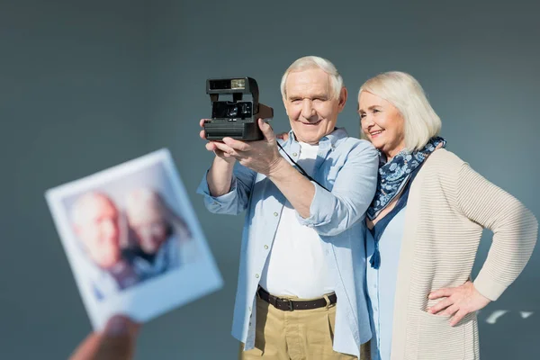 Senior couple with retro camera — Stock Photo